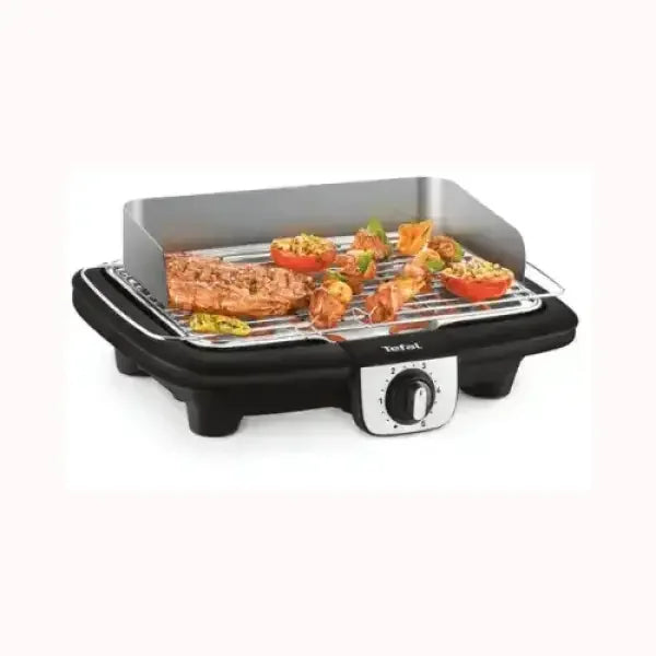 Bistecchiera elettrica TEFAL nera con regolazione temperatura e alimenti grigliati sopra